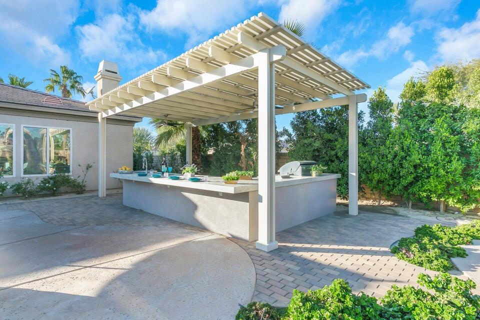 49130 Escalante Street Indio, CA 92201 - Photo 51 of 99 a view of a patio with a table and chairs under an umbrella
