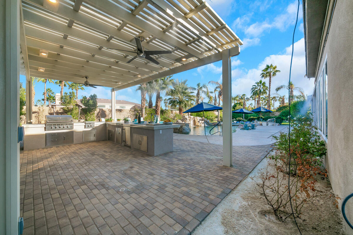 49130 Escalante Street Indio, CA 92201 - Photo 52 of 99 a view of a patio with table and chairs potted plants