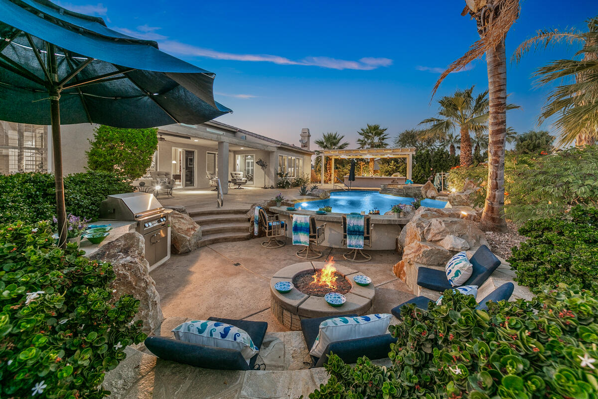 49130 Escalante Street Indio, CA 92201 - Photo 57 of 99 a view of a patio with table and chairs under an umbrella