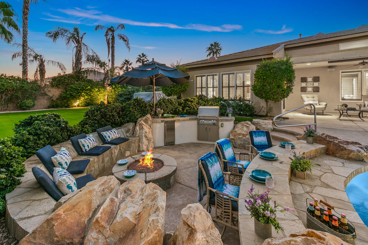 49130 Escalante Street Indio, CA 92201 - Photo 58 of 99 a view of a patio with couches table and chairs and potted plants