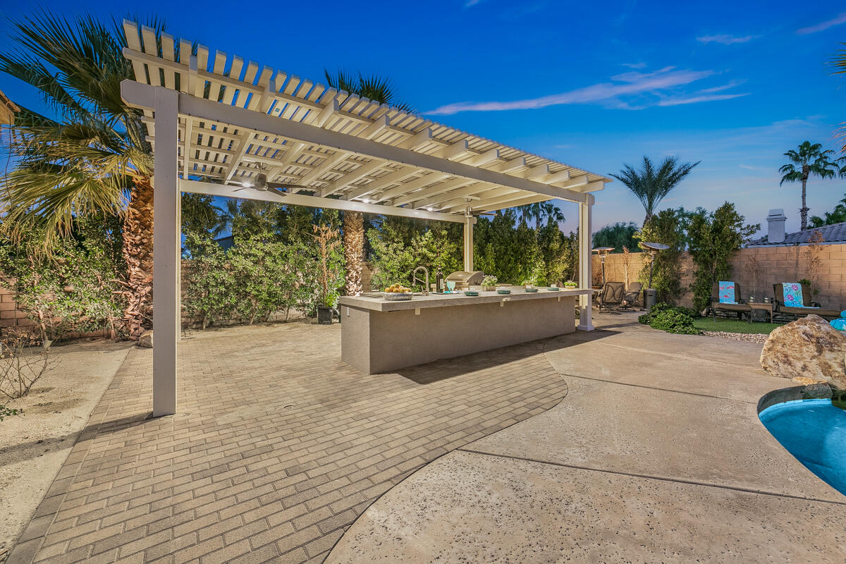 49130 Escalante Street Indio, CA 92201 - Photo 64 of 99 a view of a patio with table and chairs and potted plants