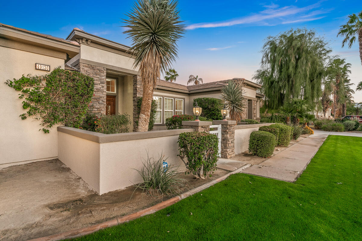 49130 Escalante Street Indio, CA 92201 - Photo 84 of 99 a front view of a house with a garden and patio