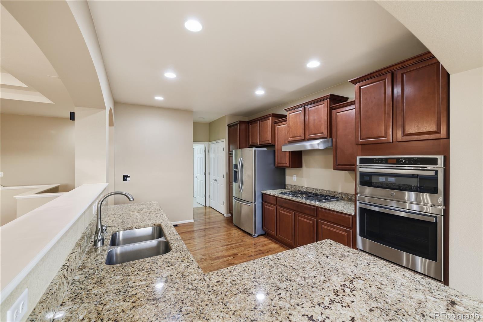 3932 Desert Ridge Circle Castle Rock, CO 80108 - Photo 11 of 49 a kitchen with stainless steel appliances granite countertop a sink stove and refrigerator