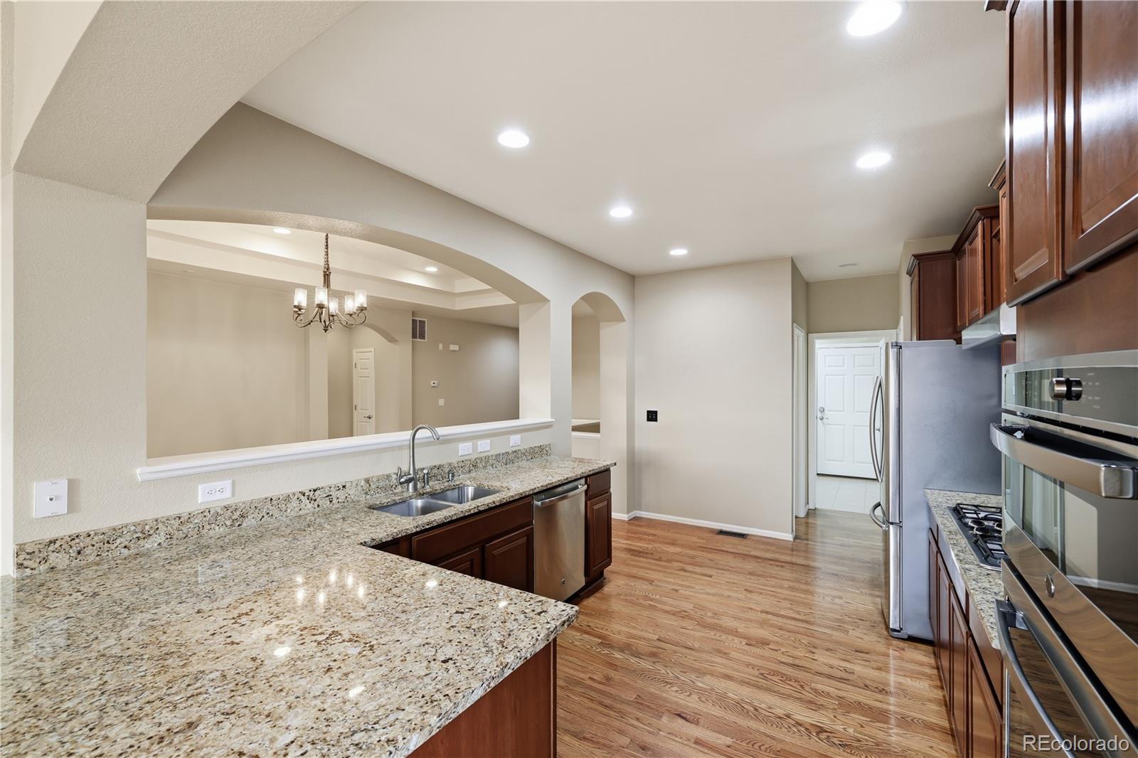 3932 Desert Ridge Circle Castle Rock, CO 80108 - Photo 12 of 49 a bathroom with a granite countertop sink a large mirror and shower