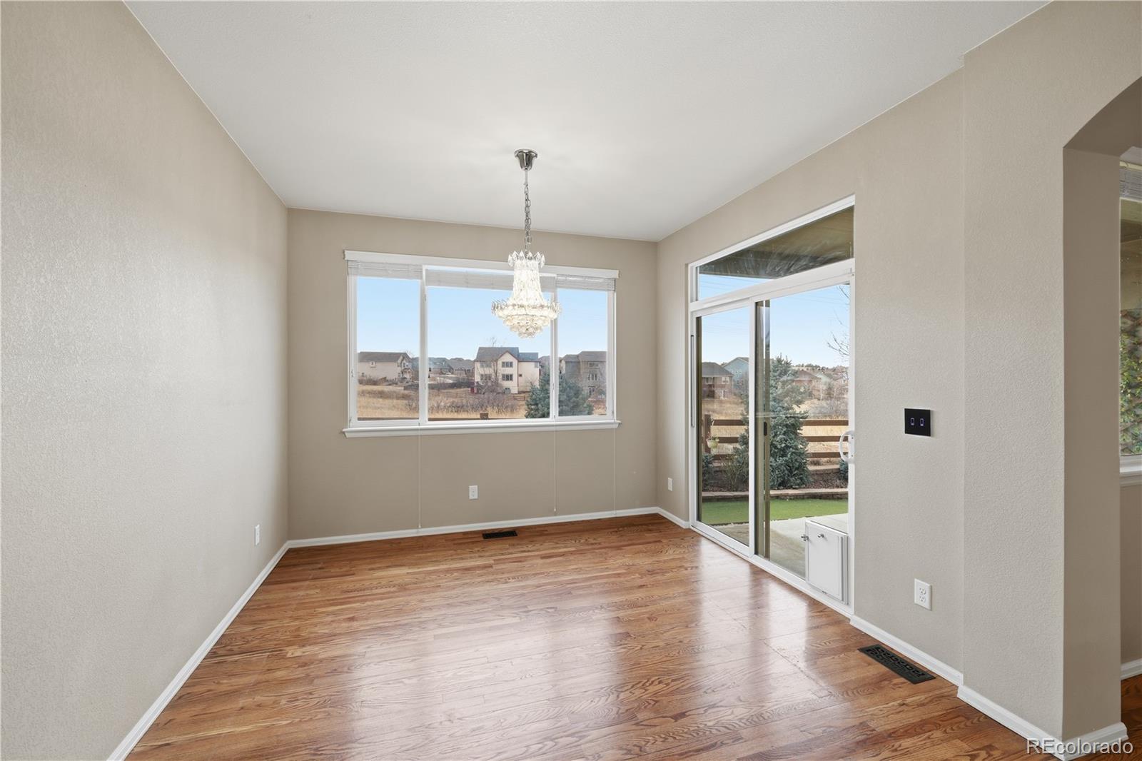 3932 Desert Ridge Circle Castle Rock, CO 80108 - Photo 13 of 49 wooden floor in an empty room with a window