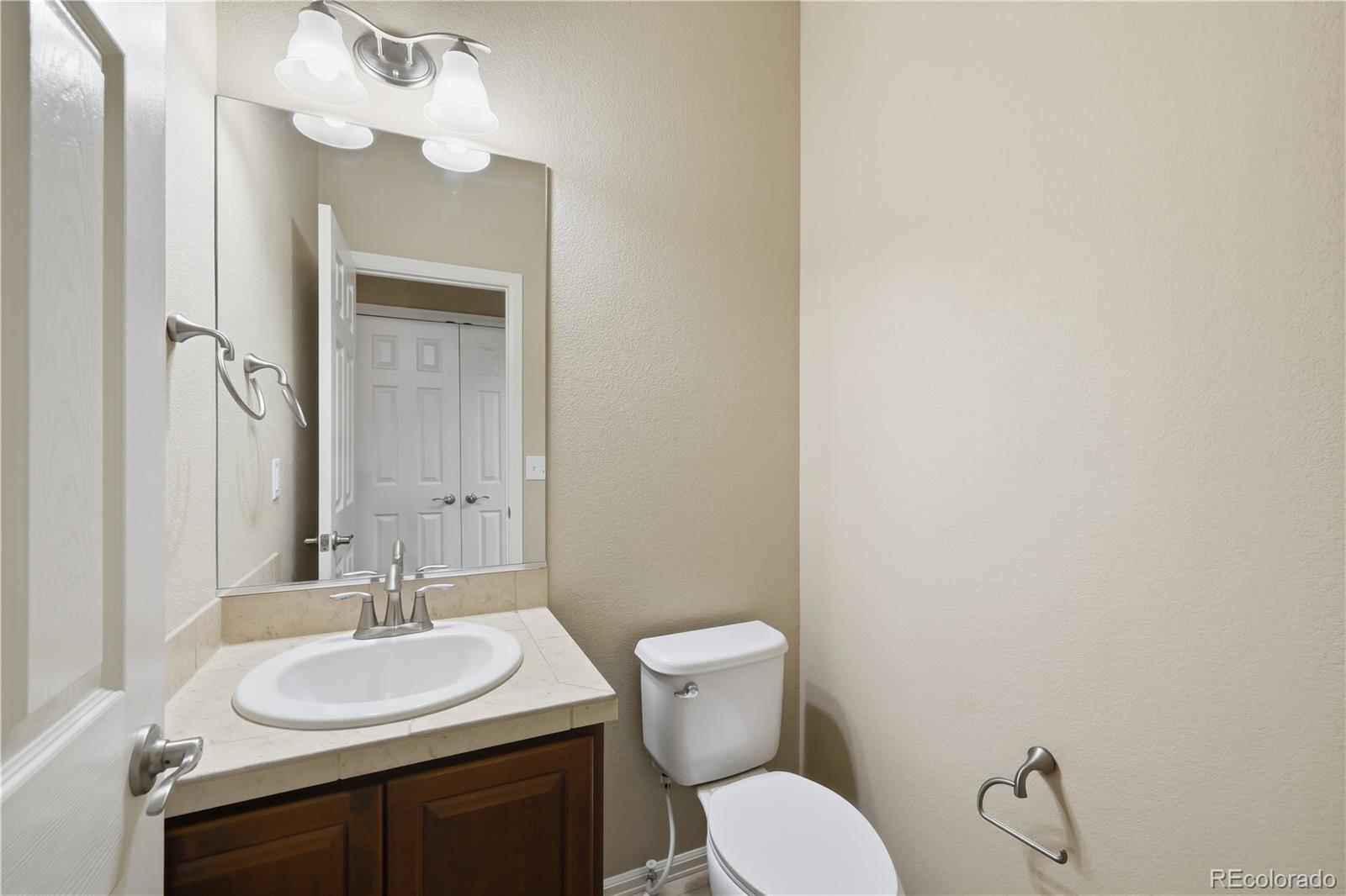 3932 Desert Ridge Circle Castle Rock, CO 80108 - Photo 19 of 49 a bathroom with a toilet sink and mirror