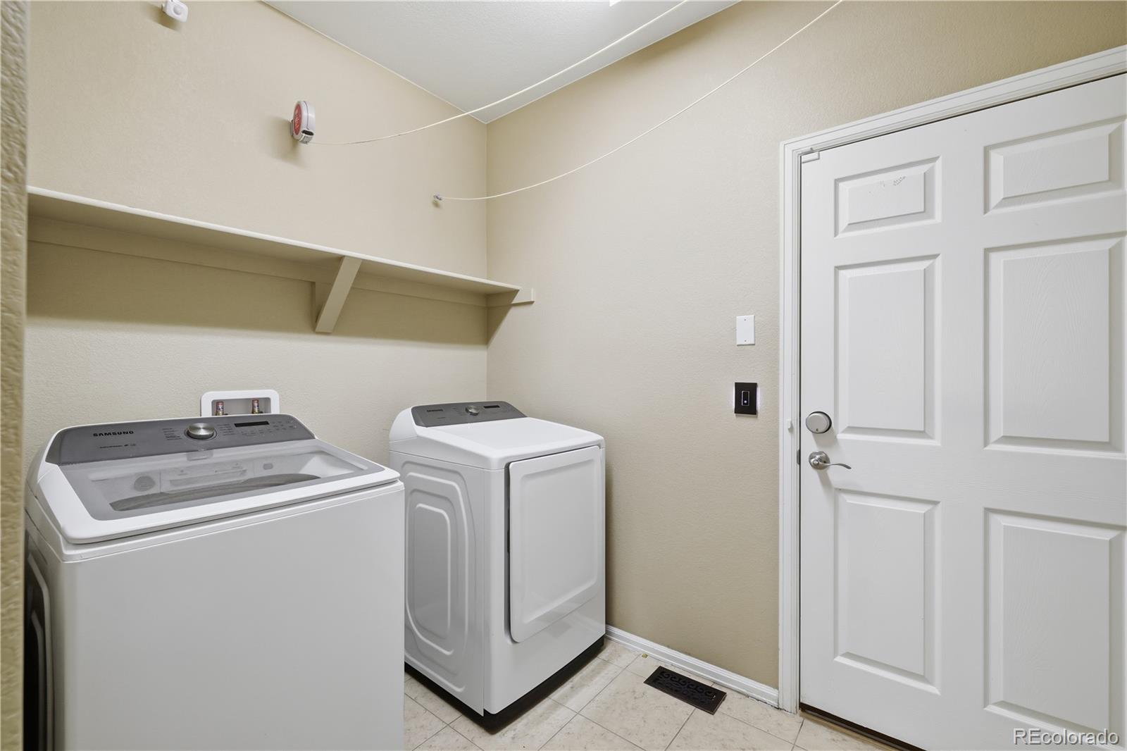3932 Desert Ridge Circle Castle Rock, CO 80108 - Photo 20 of 49 a utility room with dryer and washer