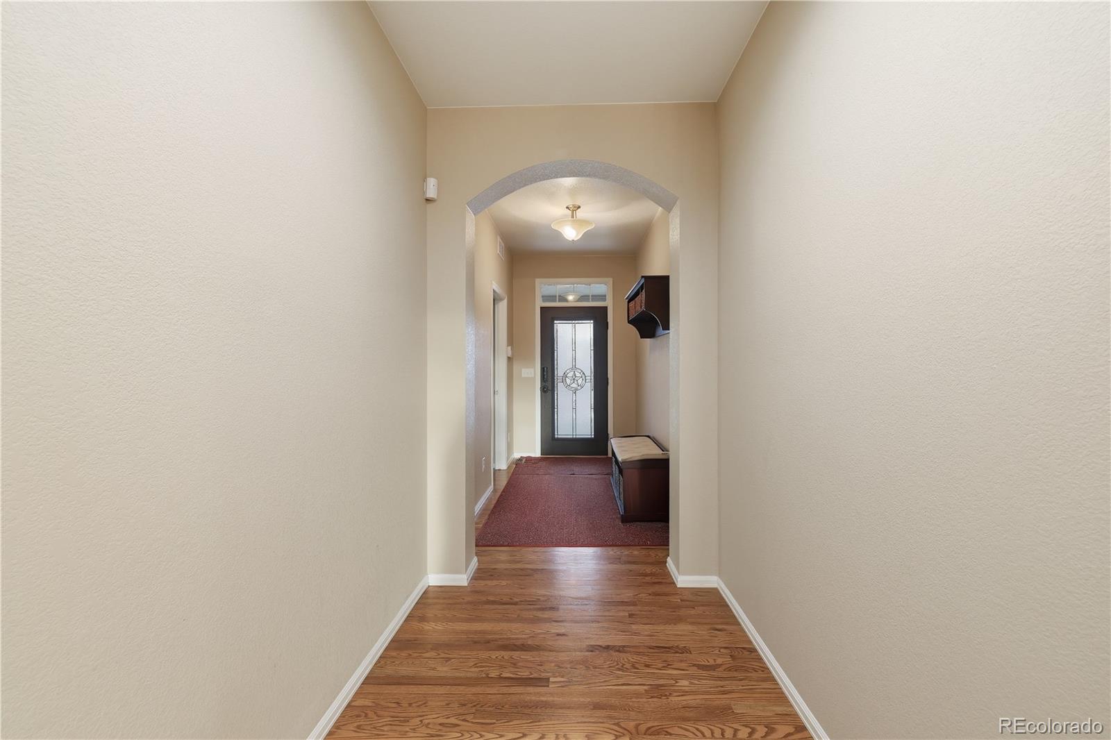 3932 Desert Ridge Circle Castle Rock, CO 80108 - Photo 21 of 49 a view of a hallway with a chandelier