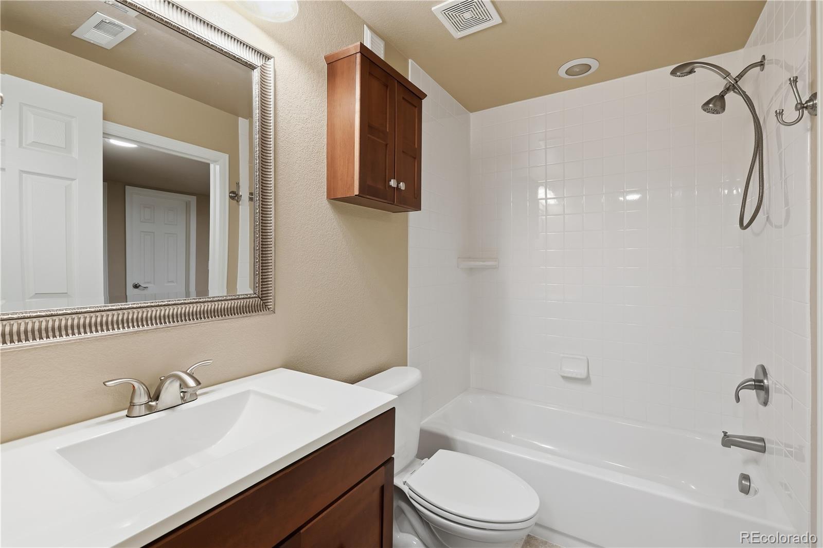3932 Desert Ridge Circle Castle Rock, CO 80108 - Photo 30 of 49 a bathroom with a sink a toilet and a bathtub
