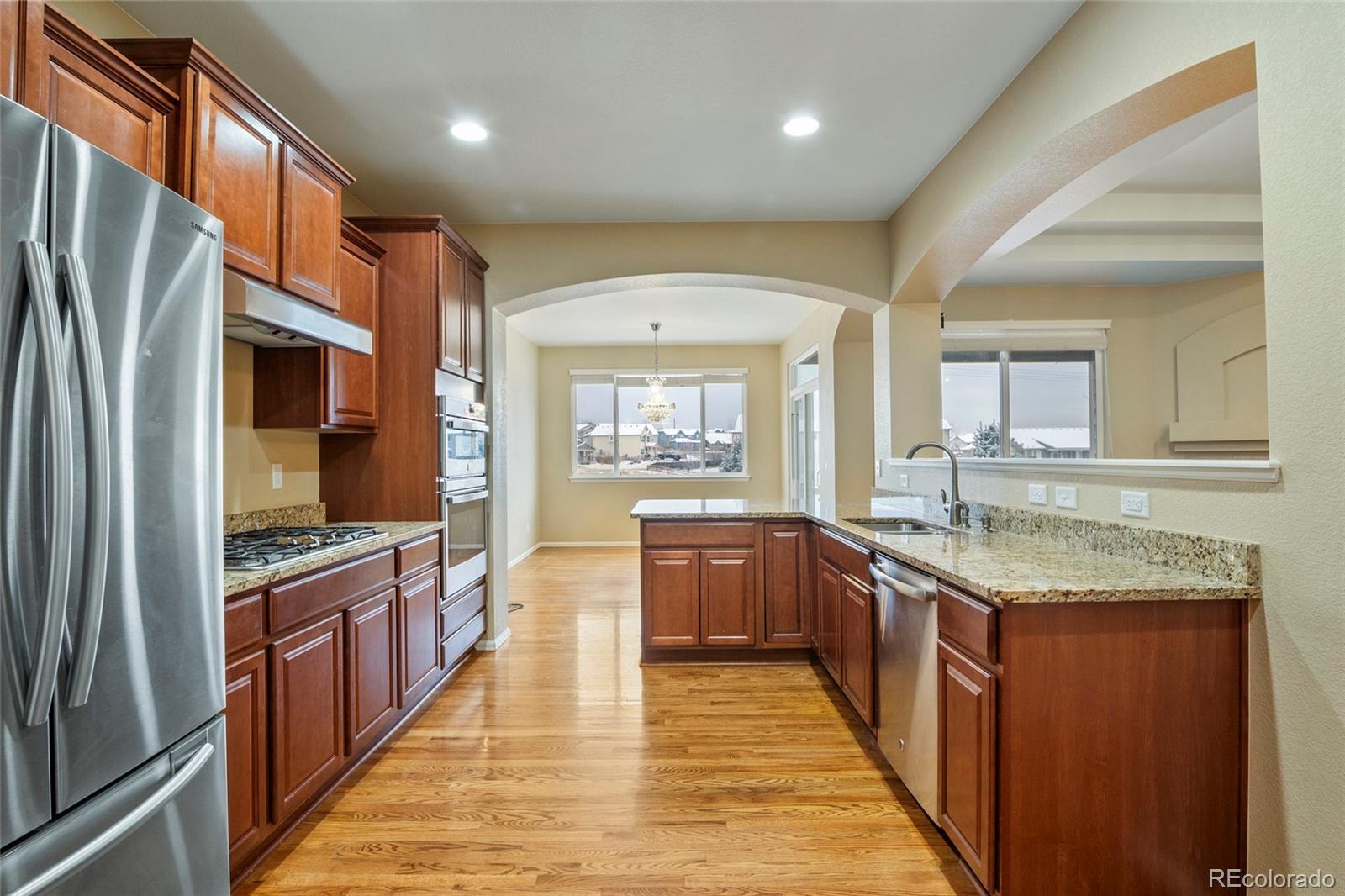 3932 Desert Ridge Circle Castle Rock, CO 80108 - Photo 35 of 49 a kitchen with stainless steel appliances granite countertop counter space a sink and a refrigerator