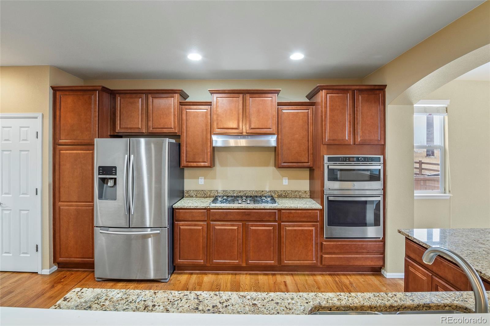 3932 Desert Ridge Circle Castle Rock, CO 80108 - Photo 36 of 49 a kitchen with stainless steel appliances granite countertop a refrigerator stove and oven