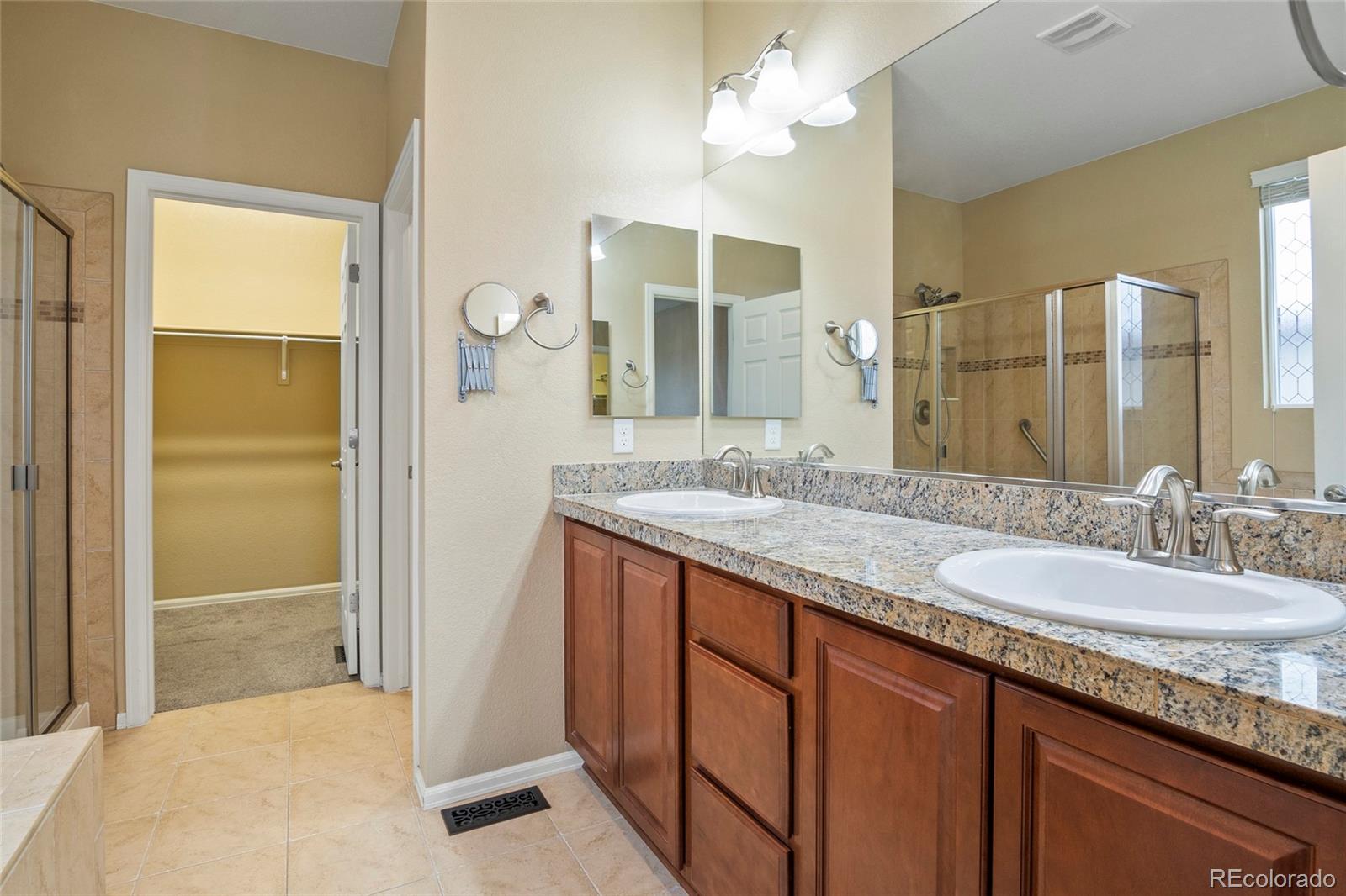 3932 Desert Ridge Circle Castle Rock, CO 80108 - Photo 37 of 49 a bathroom with a granite countertop sink and a mirror