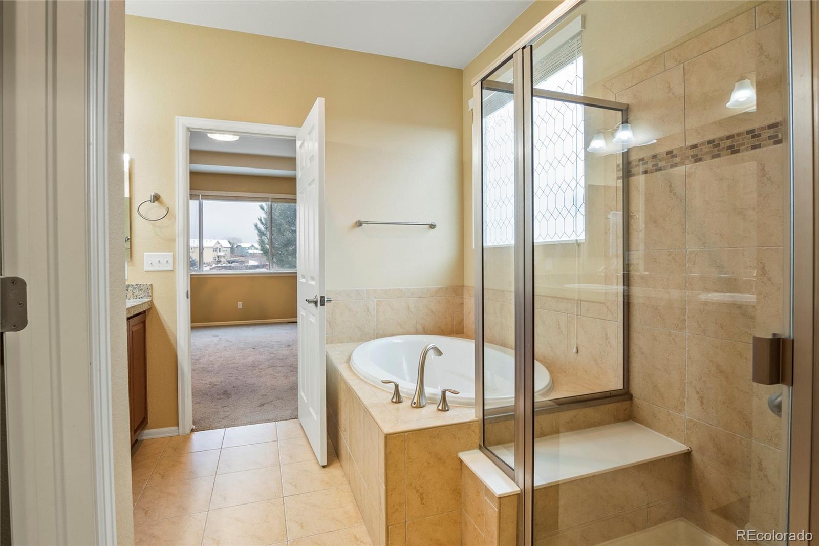 3932 Desert Ridge Circle Castle Rock, CO 80108 - Photo 38 of 49 a bathroom with a tub and shower
