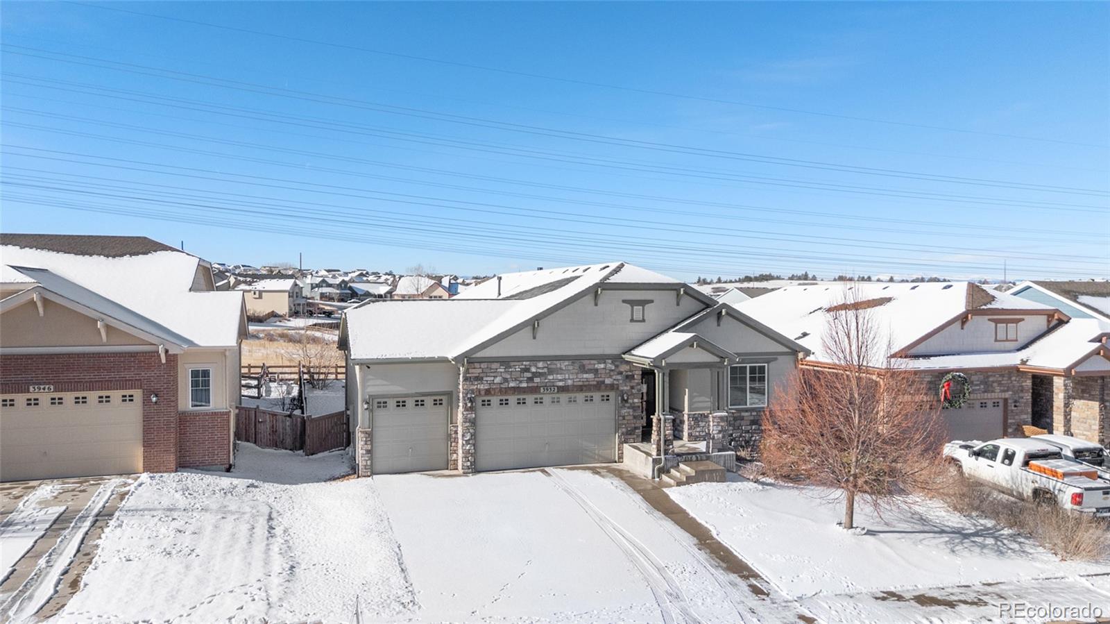 3932 Desert Ridge Circle Castle Rock, CO 80108 - Photo 49 of 49 a bedroom with a bed and a chandelier