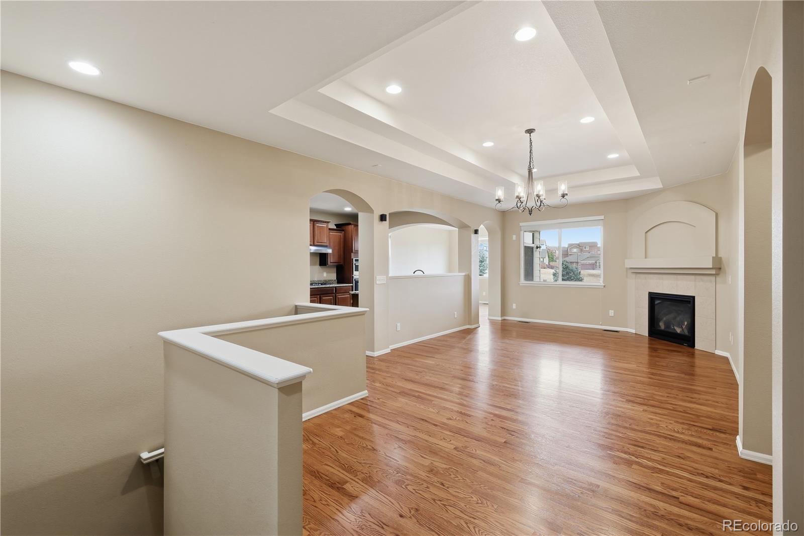 3932 Desert Ridge Circle Castle Rock, CO 80108 - Photo 6 of 49 wooden floor in an empty room with a fireplace