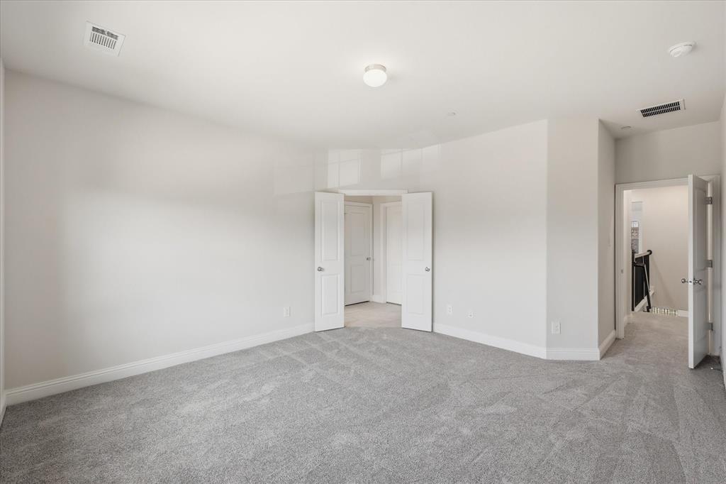 519 Sequoia Street Allen, TX 75002 - Photo 19 of 38 Spacious room with light gray carpeting, neutral wall paint, white trim, and recessed lighting