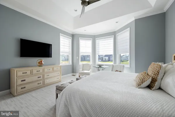 a bedroom with a bed and a large window with outer view