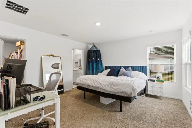 a bedroom with a bed and a desk