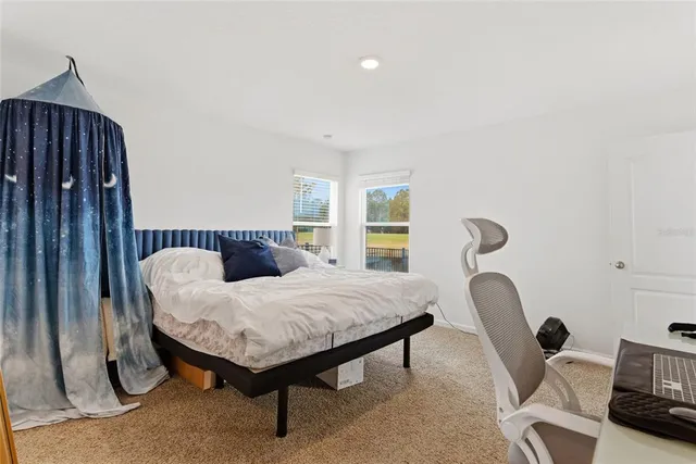 a bedroom with furniture and a window