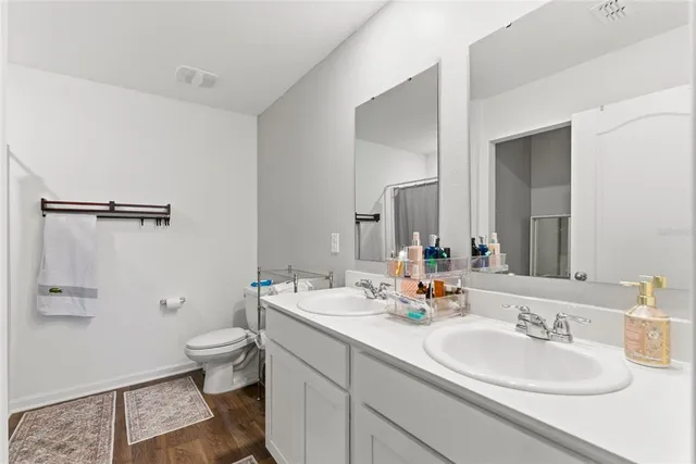 a bathroom with a toilet sink and mirror