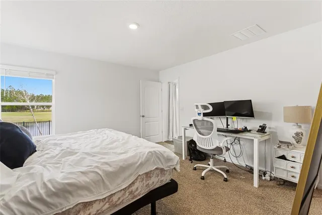 a bedroom with a workspace