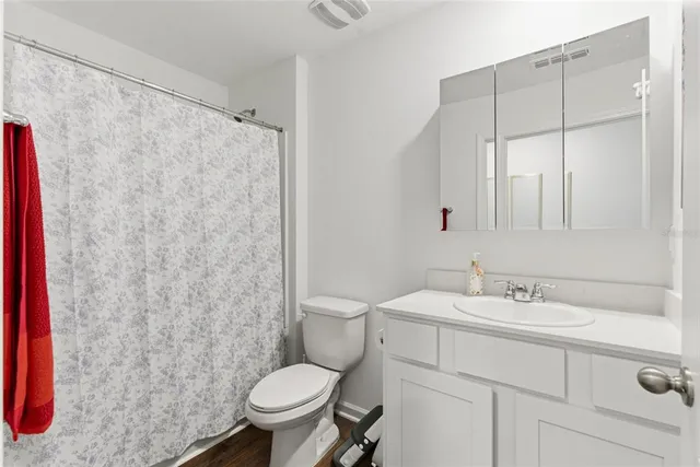 a bathroom with a sink toilet and shower