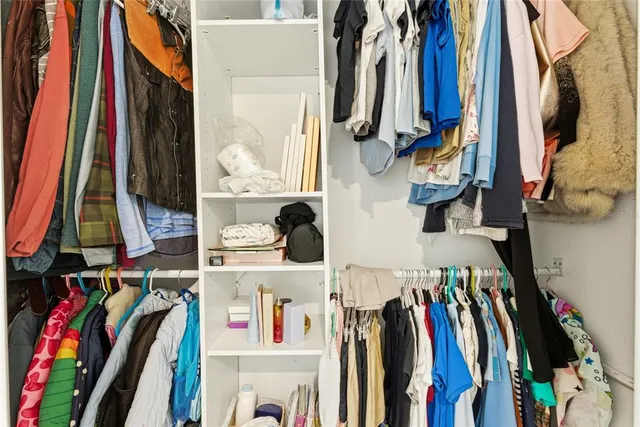 a bedroom with furniture and a book shelf