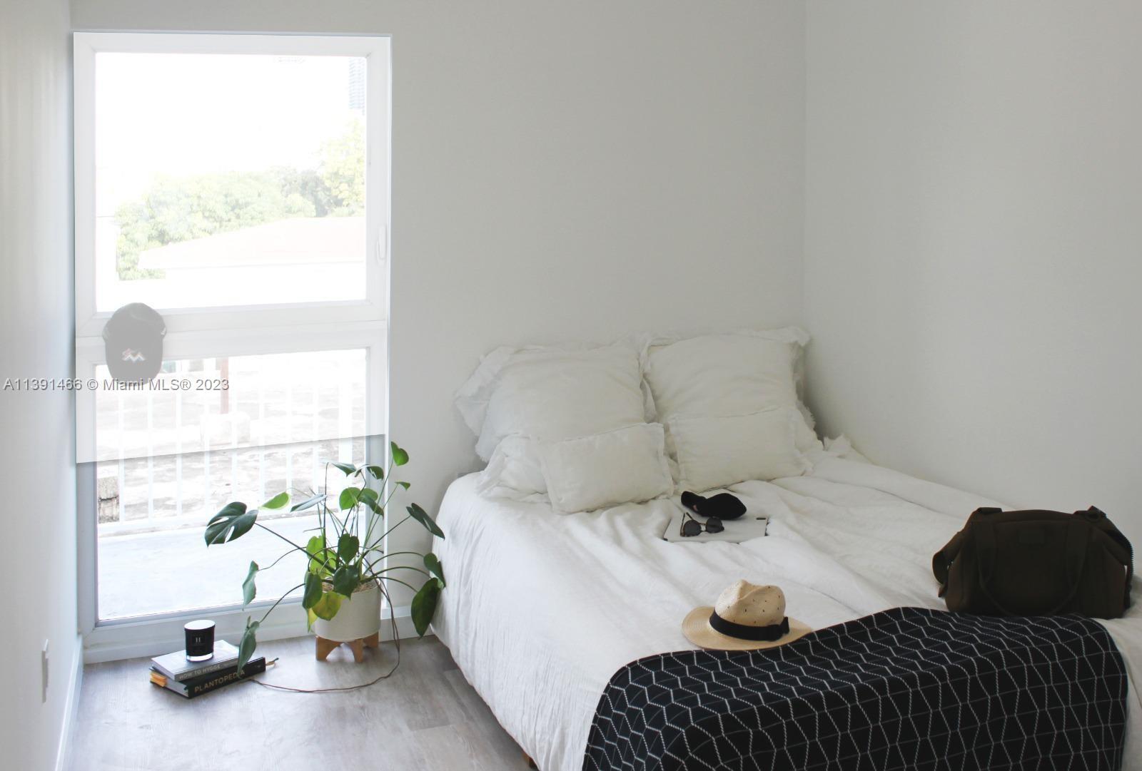 542 Southwest 7th Street Miami, FL 33130 - Photo 16 of 22 a bedroom with a bed and a window