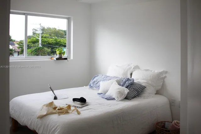 a bedroom with a bed and window