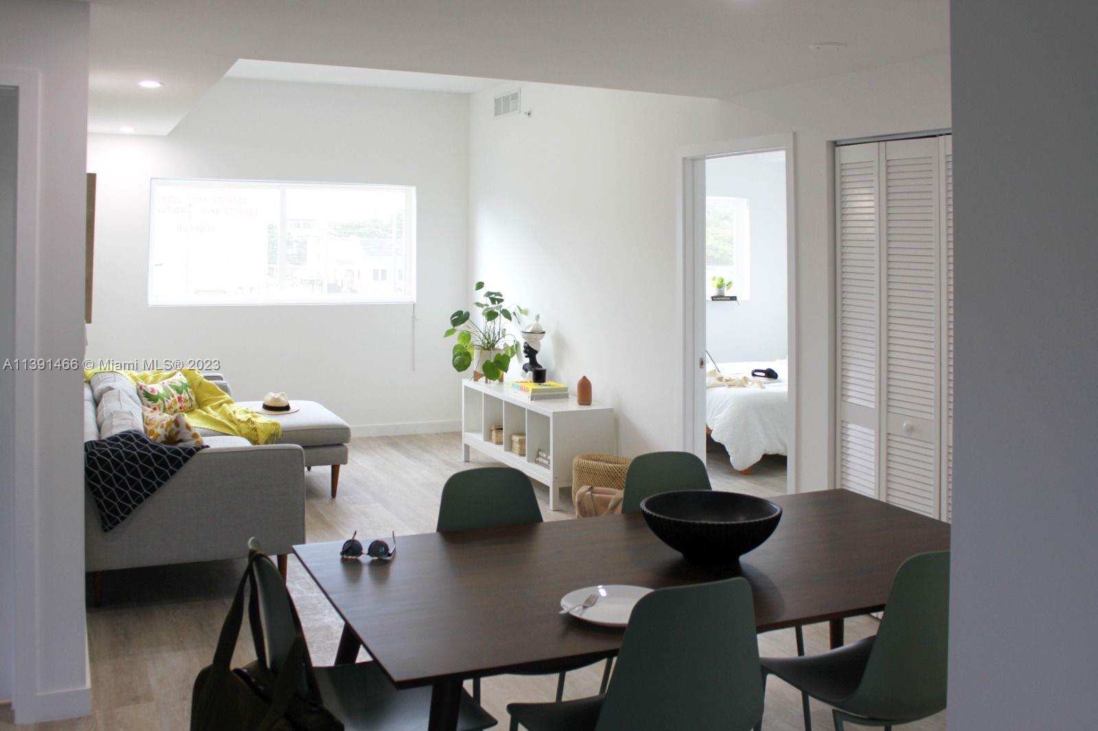 542 Southwest 7th Street Miami, FL 33130 - Photo 20 of 22 a view of a dining room with furniture and wooden floor