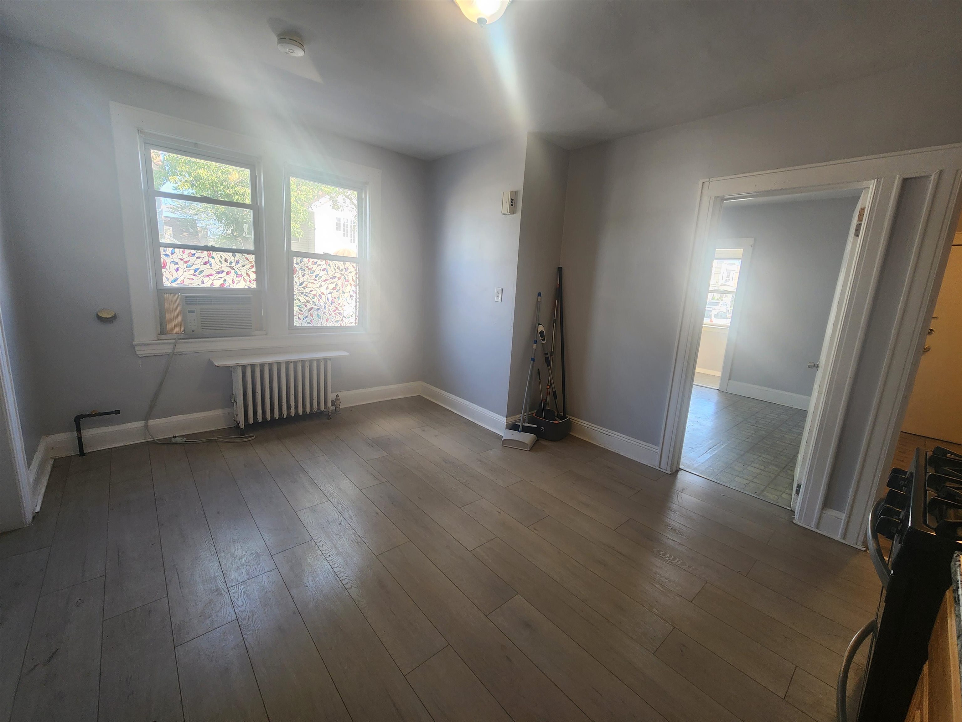 261 Centre Avenue, Unit 1 Secaucus, NJ 07094 - Photo 8 of 11 an empty room with wooden floor and windows