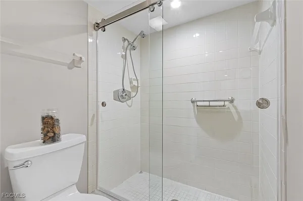 a bathroom with a shower and toilet