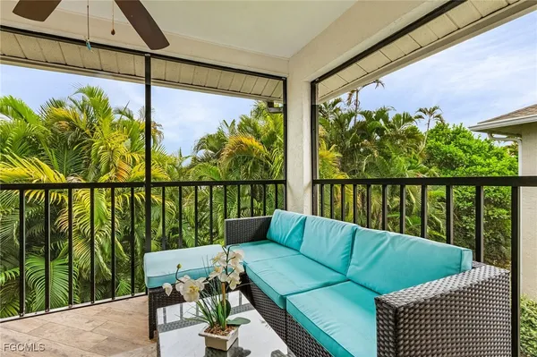 a balcony with wooden floor and outdoor seating