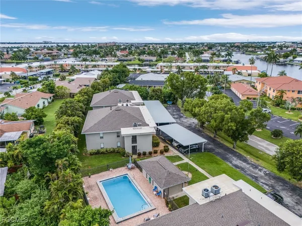 an aerial view of multiple houses with yard