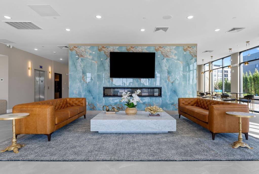 54 Flagship Street, Unit 421 Bayonne, NJ 07002 - Photo 4 of 16 a living room with furniture and a flat screen tv