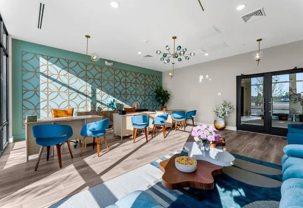 a living room with furniture and a chandelier