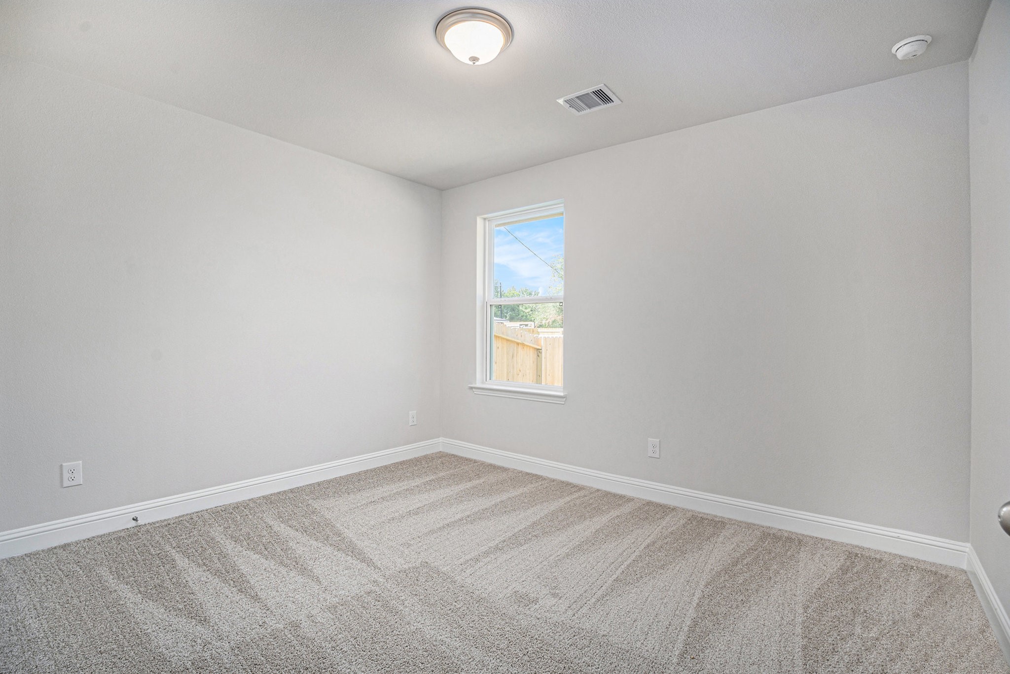424 Bryan Street Angleton, TX 77515 - Photo 13 of 17 an empty room with a window
