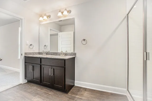 a bathroom with a sink vanity and a mirror