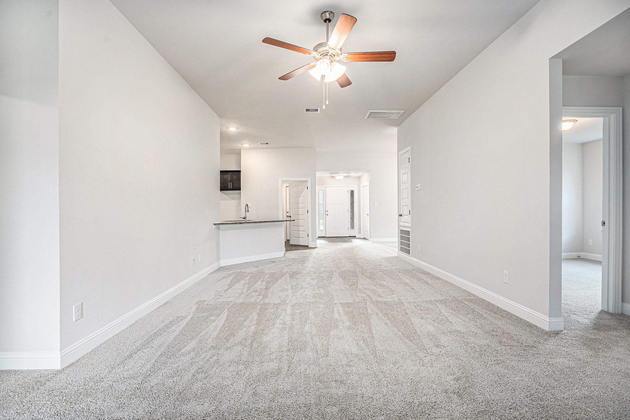 424 Bryan Street Angleton, TX 77515 - Photo 2 of 17 a view of an empty room with a ceiling fan