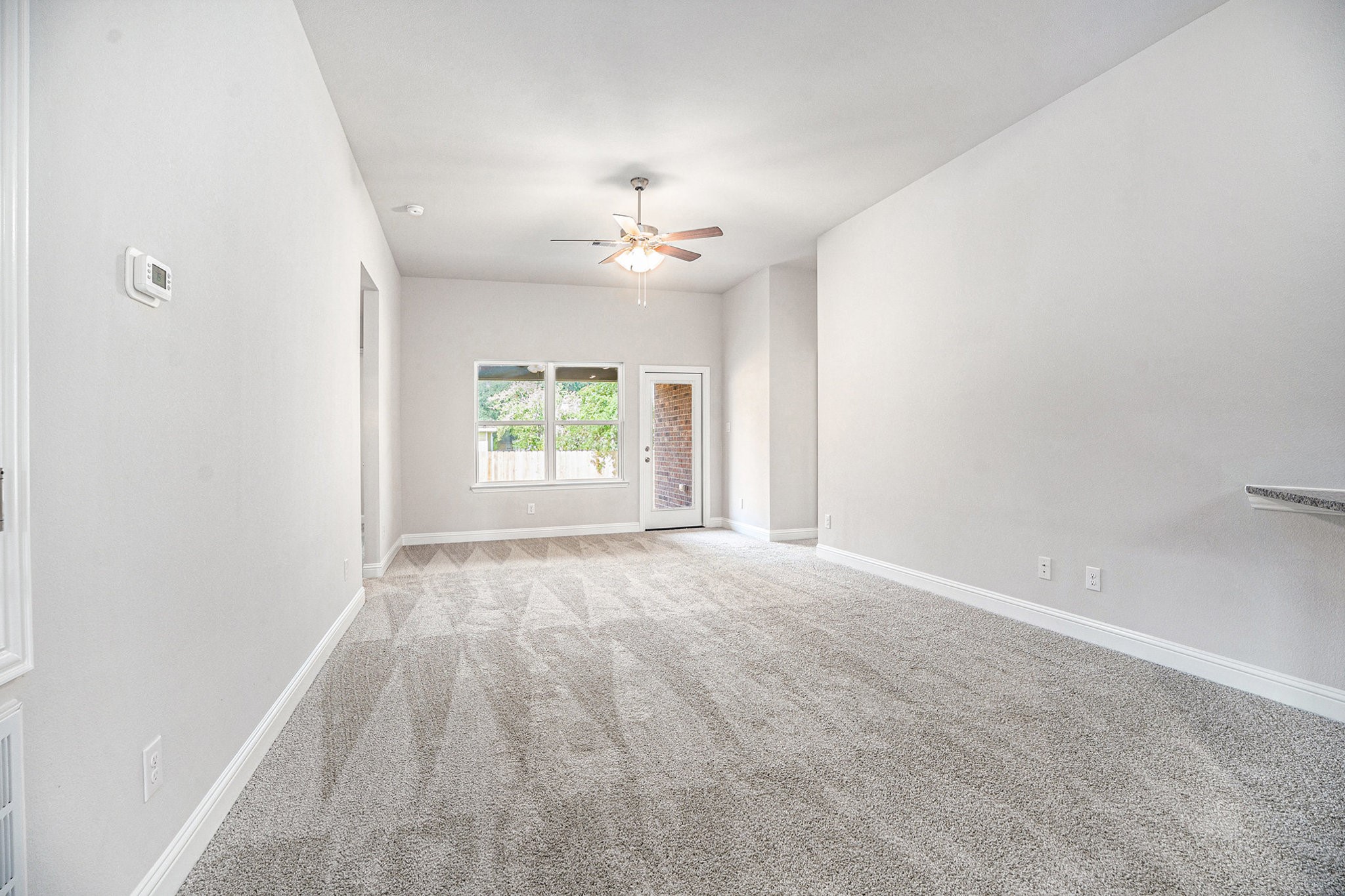 424 Bryan Street Angleton, TX 77515 - Photo 3 of 17 an empty room with windows and ceiling fan