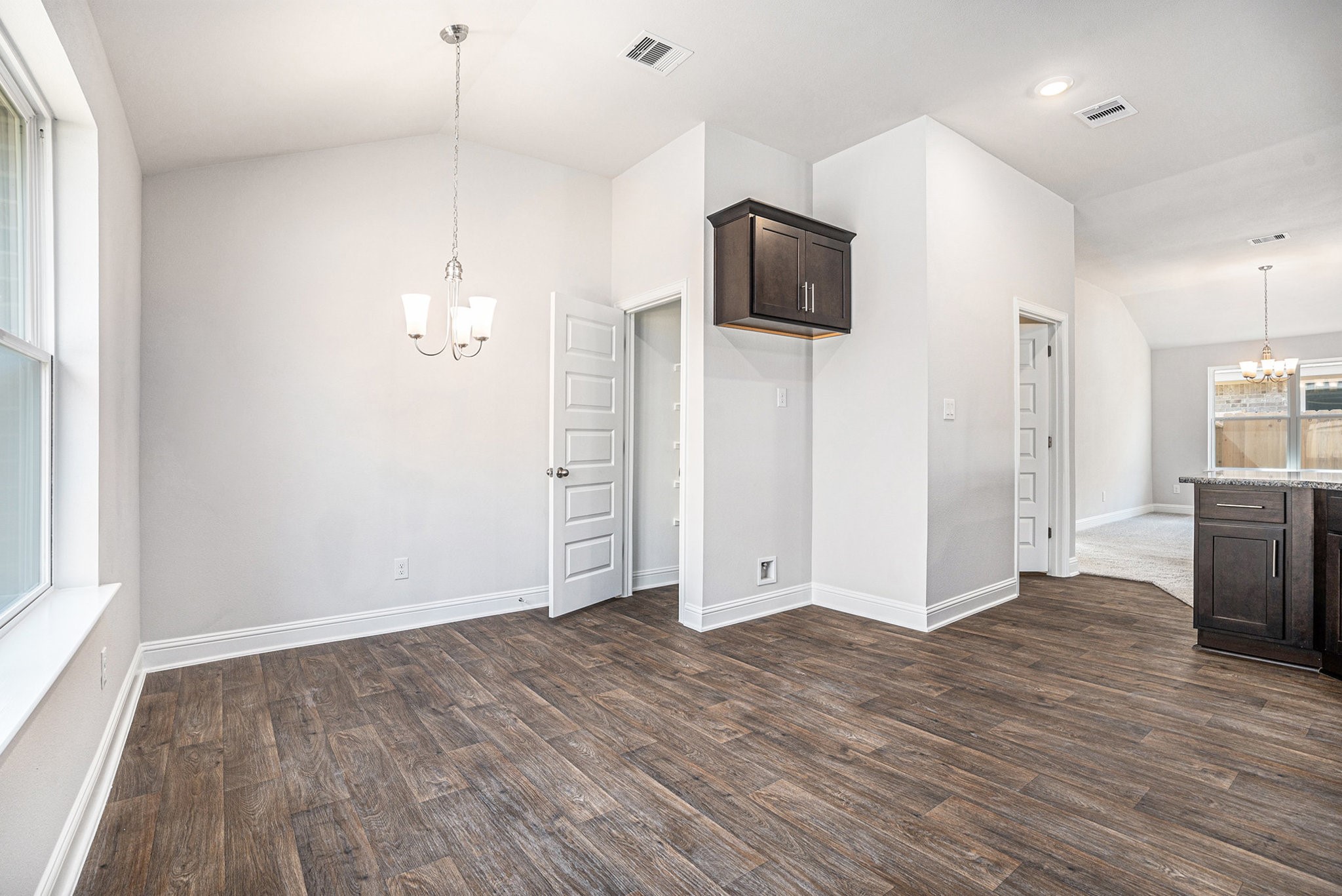 424 Bryan Street Angleton, TX 77515 - Photo 5 of 17 wooden floor in an empty room with a kitchen