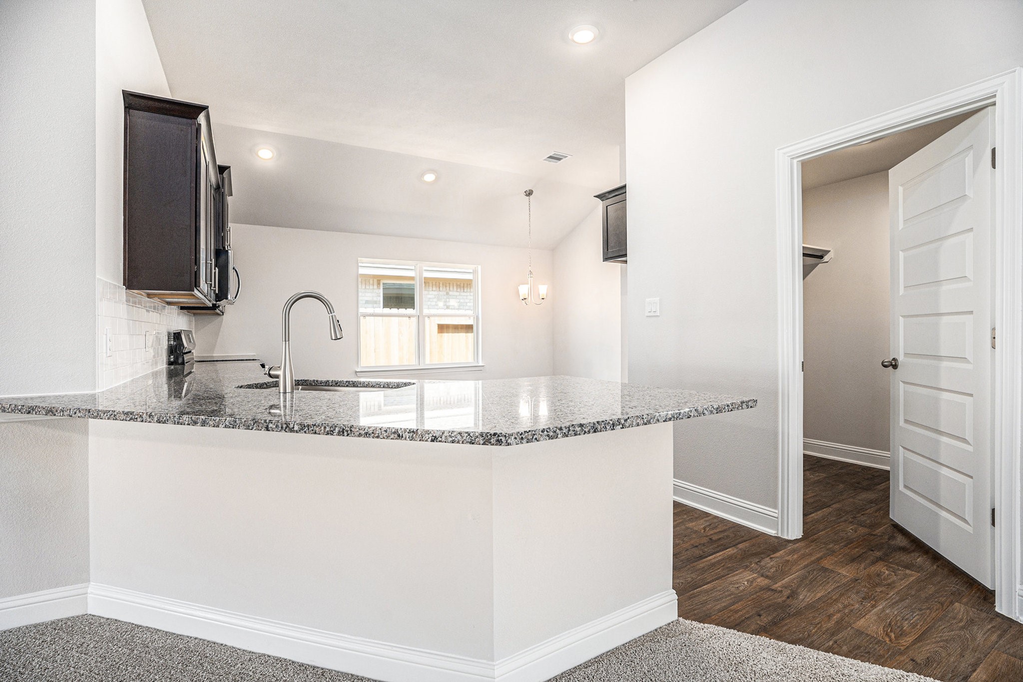 424 Bryan Street Angleton, TX 77515 - Photo 6 of 17 a bathroom with granite countertop a sink and a mirror