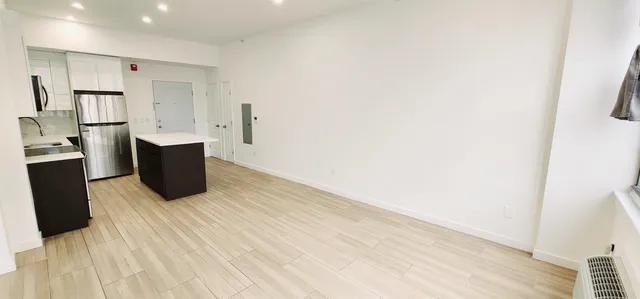 a room with wooden floor and electronic appliances