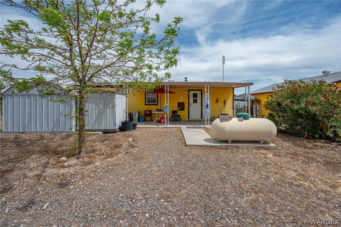 2465 Egar Road Golden Valley, AZ 86413 - Photo 56 of 98 The property features a yellow exterior and a covered patio area