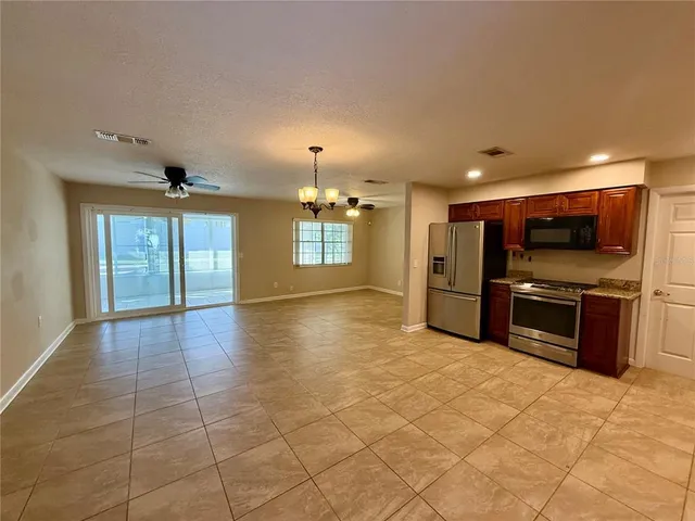 a view of a kitchen with a sink and a stove top oven
