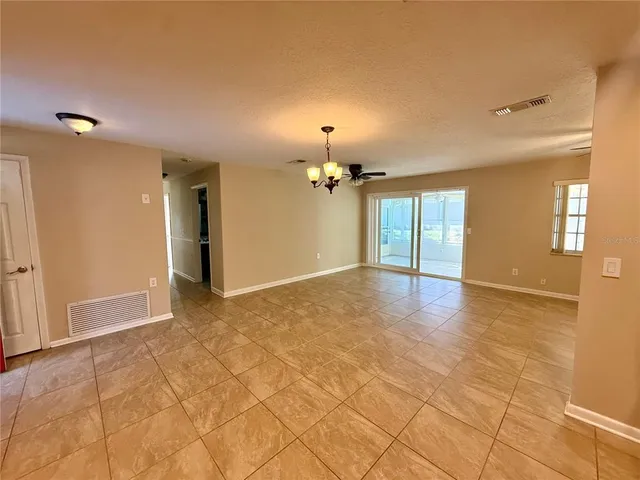 a view of a kitchen with a sink and a chandelier fan
