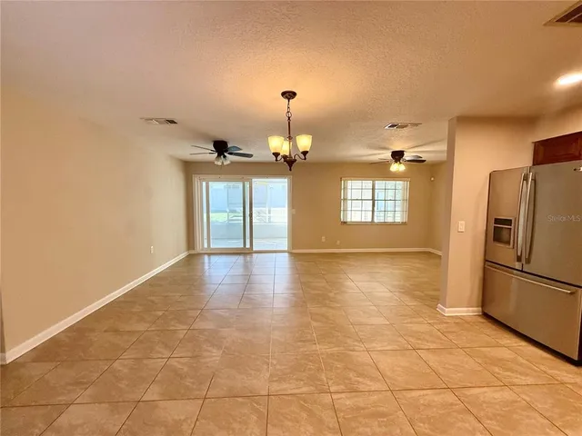 a view of a kitchen with a sink and a refrigerator