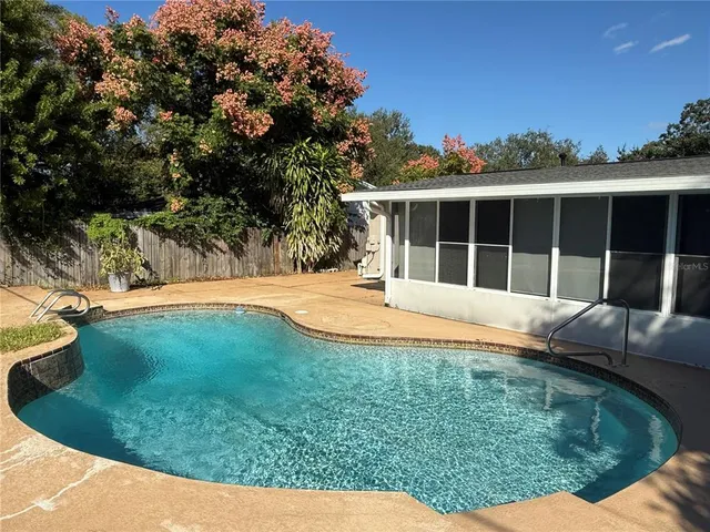 a view of a house with a backyard