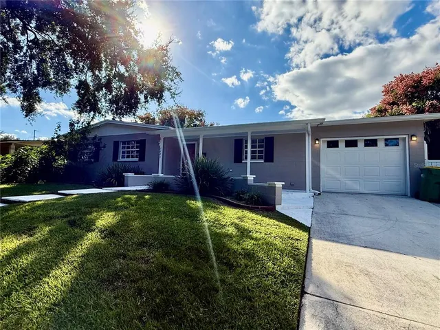 a view of a house with a backyard porch and sitting area