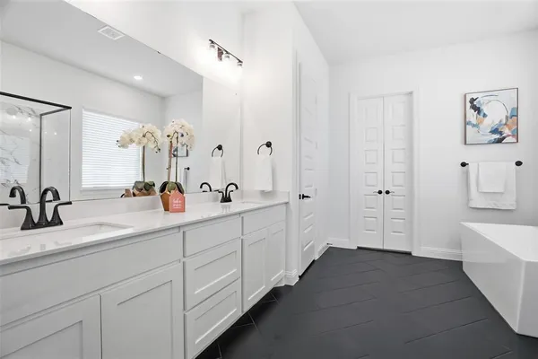 a bathroom with a bathtub and a shower